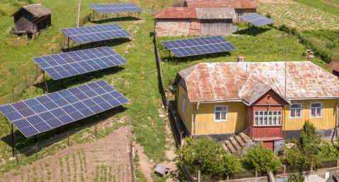 house, barns and solar panels in a wide landscape
