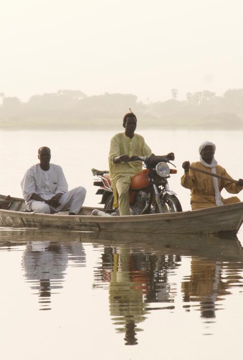 A boat taxi transports people and goods across the lake near Baga Sola, Chad