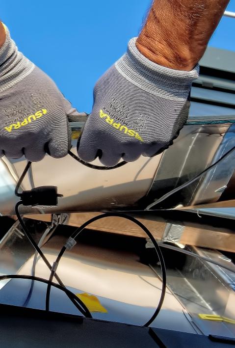 Craftsmen install a solar cell.