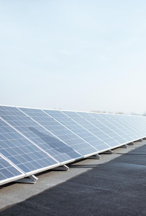 engineer taking notes on a roof with photovoltaik panels