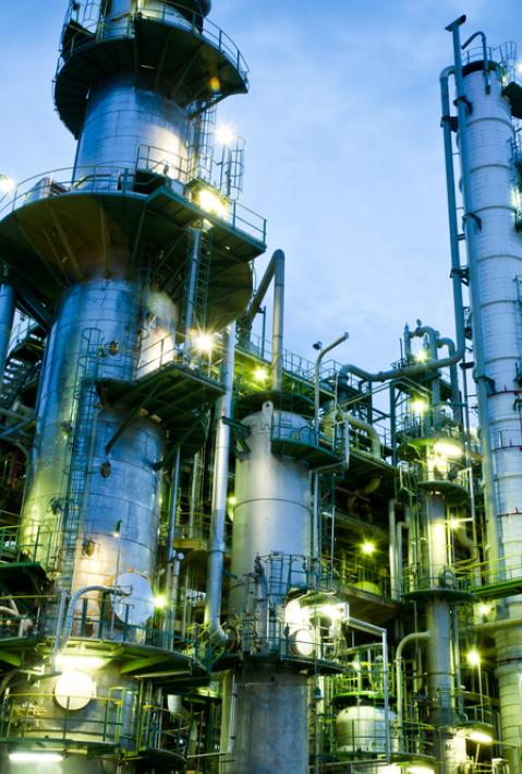 Column tower in petrochemical plant at twilight