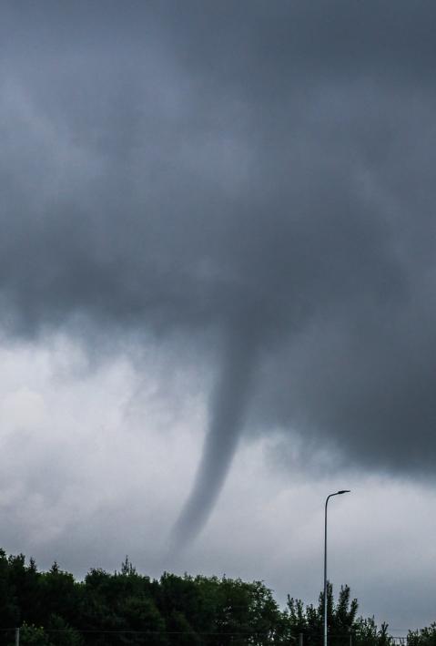 Kaunas, Lithuania - 08 20 2017: Small tornado seen above a group of trees.
