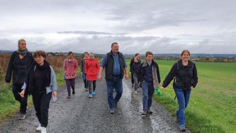 Project team goes out into the field with the farmer under grey skies