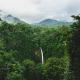Waterfall within the tropical rainforest surrounded by mountains