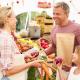 Family Buying Fresh Vegetables At Farmers Market Stall